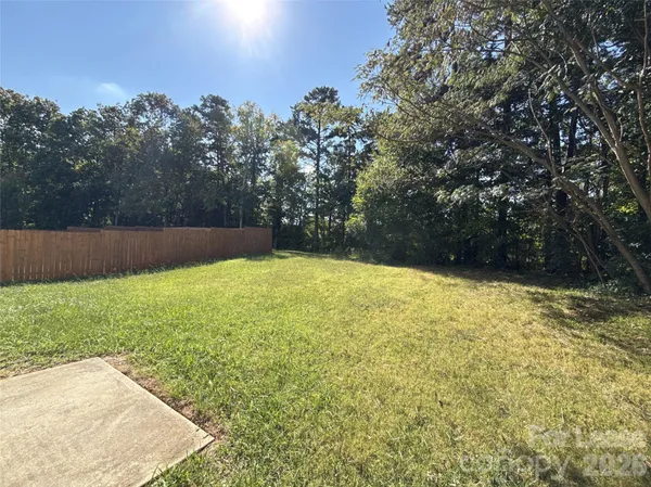 a view of yard with swimming pool and green space