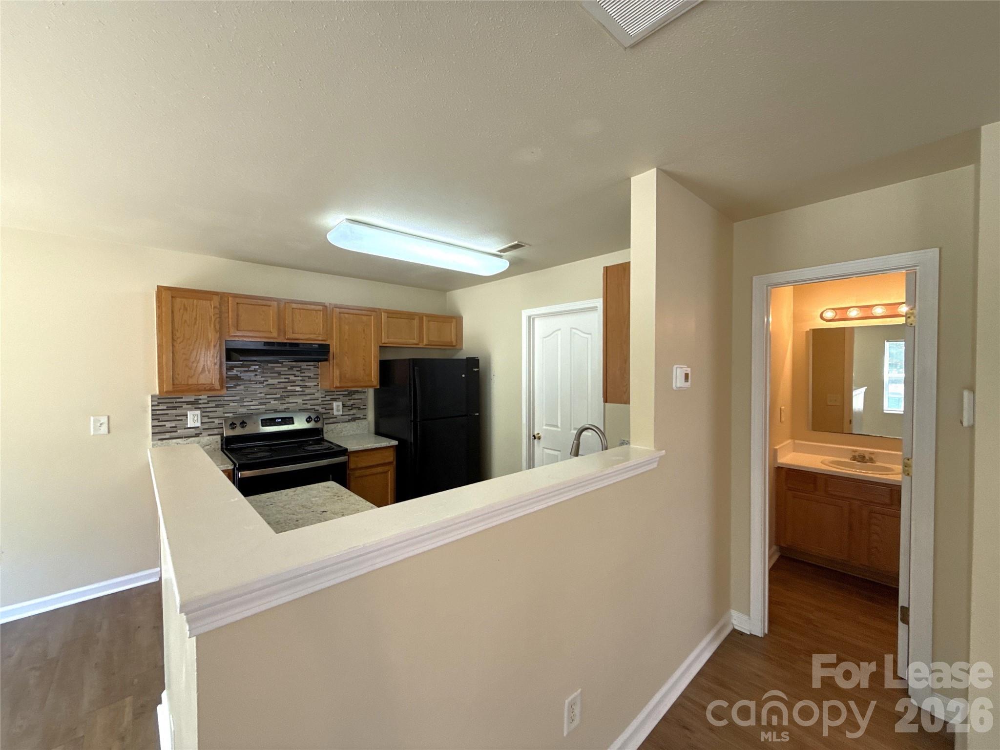 6831 Sunman Road Charlotte, NC 28216 - Photo 5 of 14 a kitchen with stainless steel appliances a refrigerator and a stove top oven