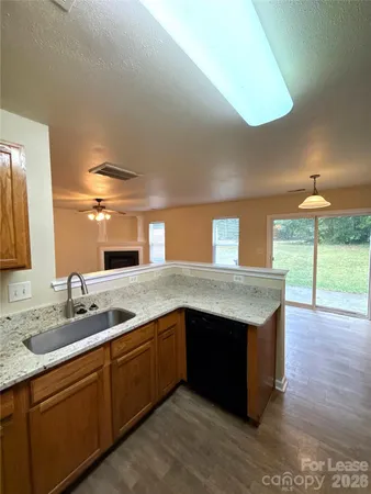 a kitchen with stainless steel appliances granite countertop a sink and a stove