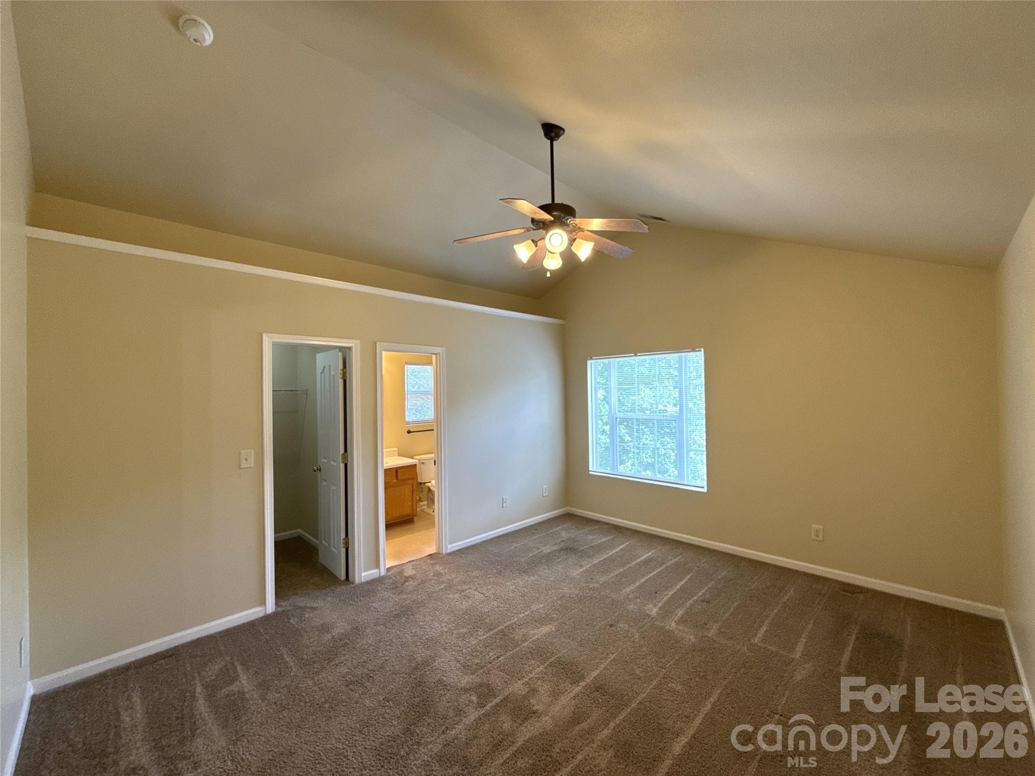 6831 Sunman Road Charlotte, NC 28216 - Photo 8 of 14 a view of an empty room with window and chandelier fan