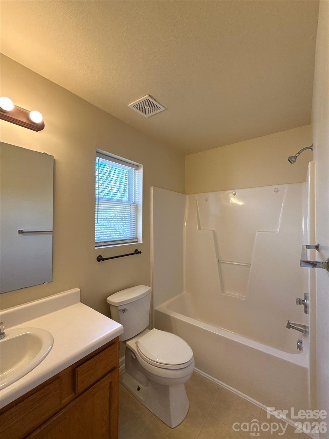 6831 Sunman Road Charlotte, NC 28216 - Photo 9 of 14 a bathroom with a sink a toilet and shower