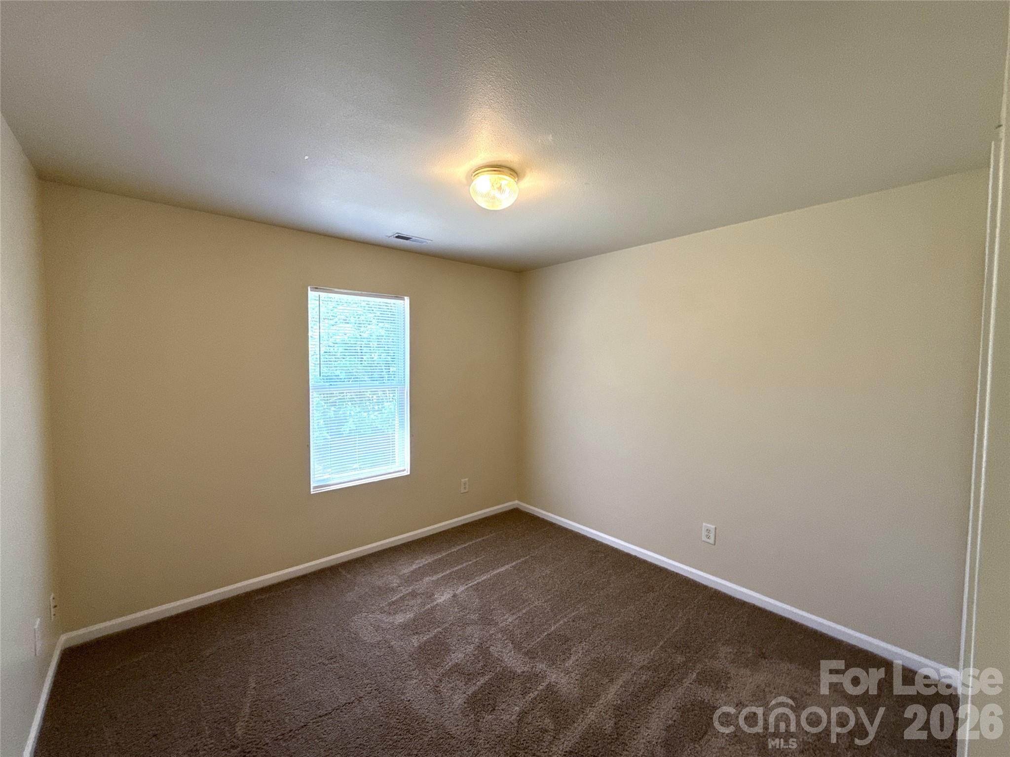 6831 Sunman Road Charlotte, NC 28216 - Photo 10 of 14 an empty room with a window