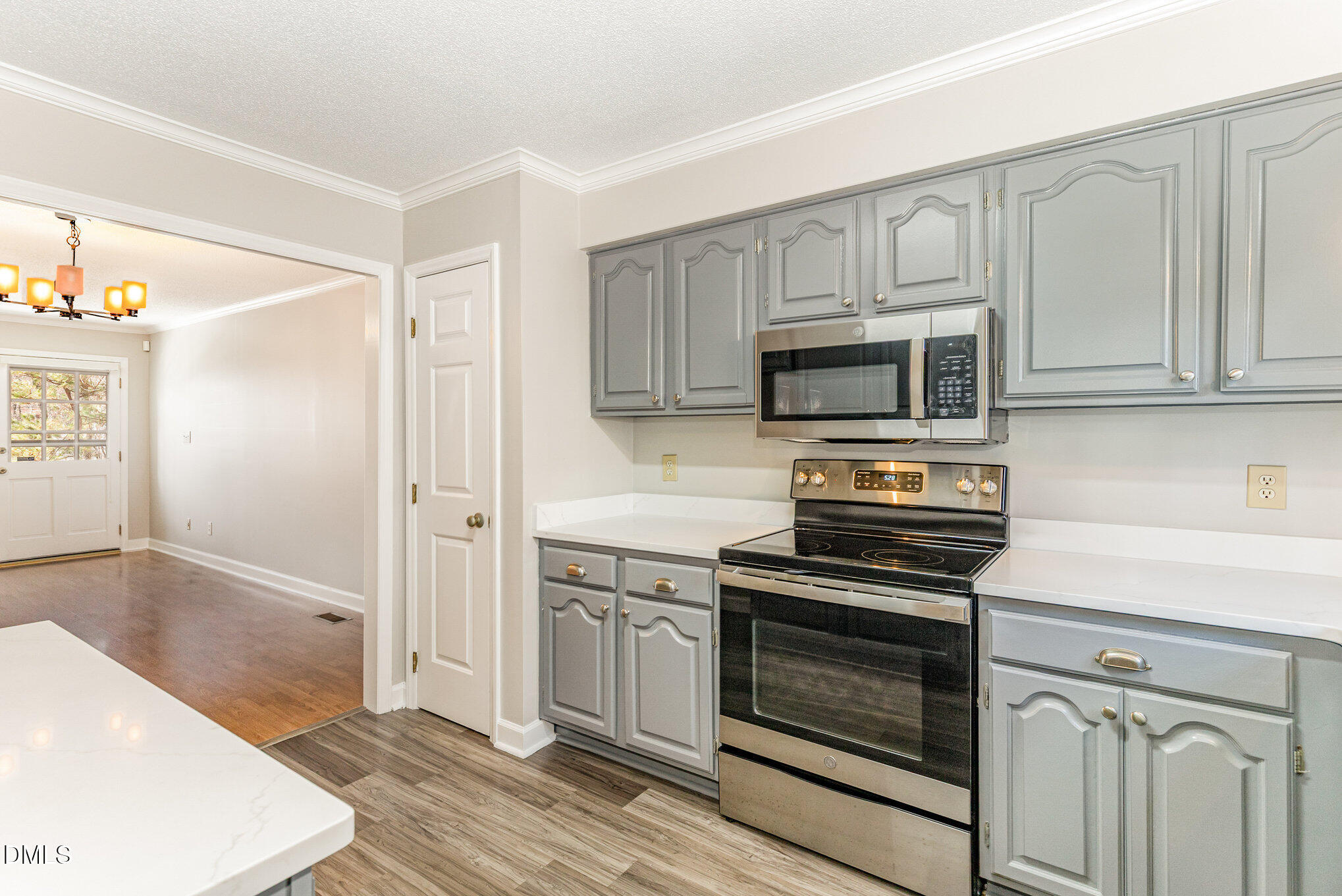 4534 Hamptonshire Drive Raleigh, NC 27613 - Photo 13 of 27 a kitchen with granite countertop a stove and a sink