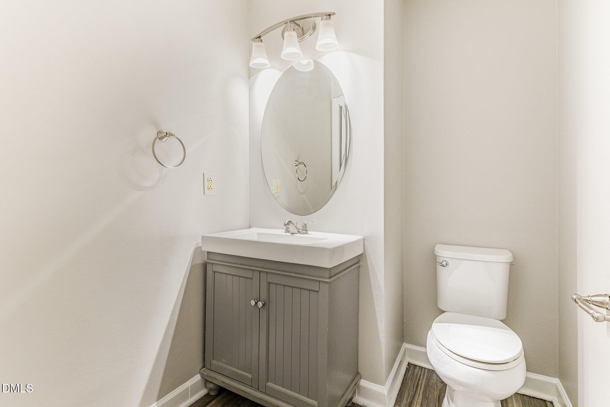 4534 Hamptonshire Drive Raleigh, NC 27613 - Photo 14 of 27 a bathroom with a toilet a sink and mirror