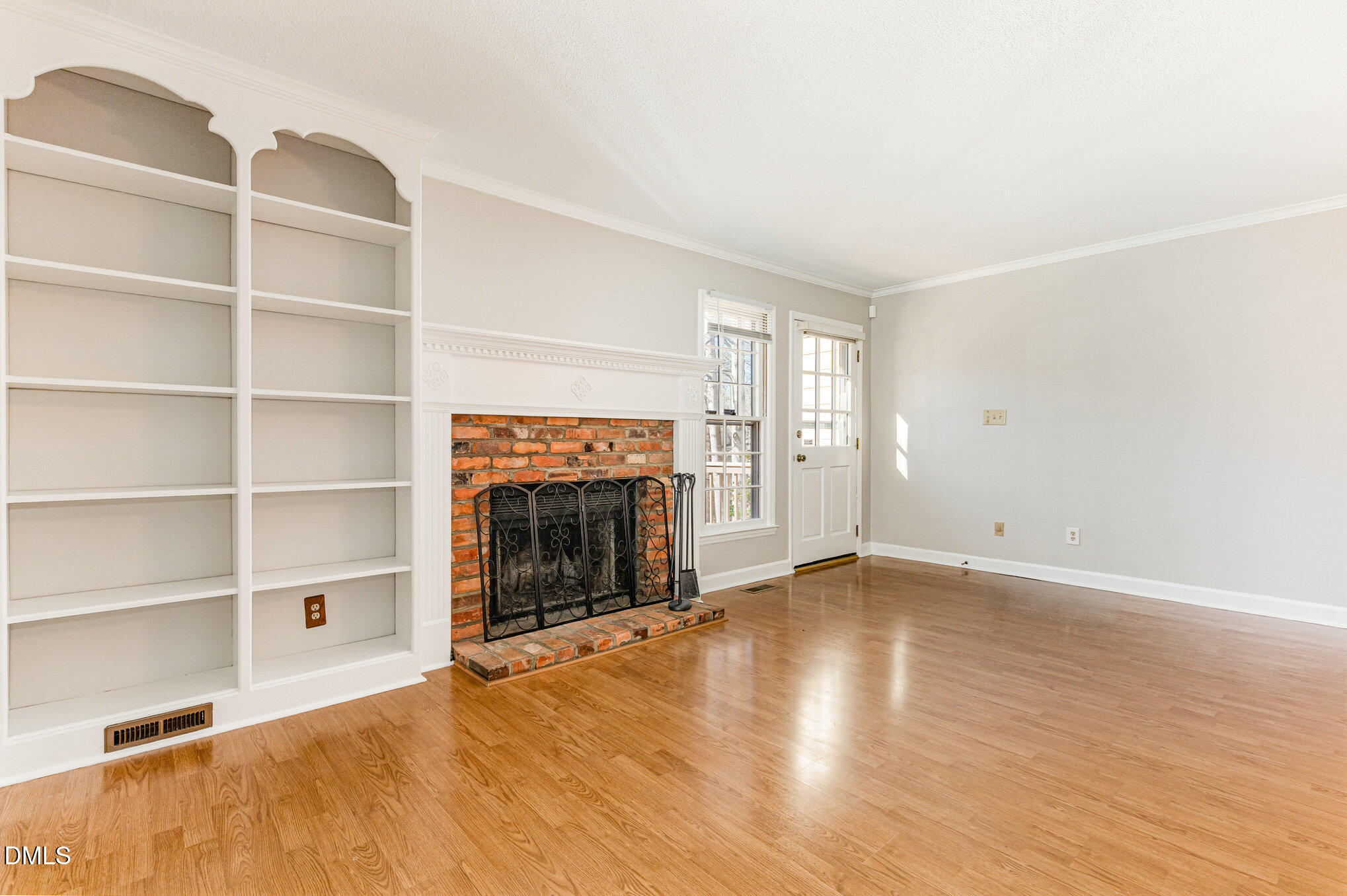 4534 Hamptonshire Drive Raleigh, NC 27613 - Photo 4 of 27 a view of an empty room with a fireplace and a window