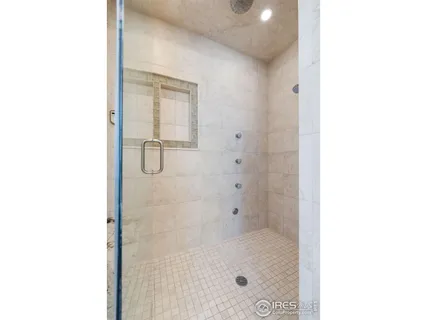 a bathroom with a glass shower door
