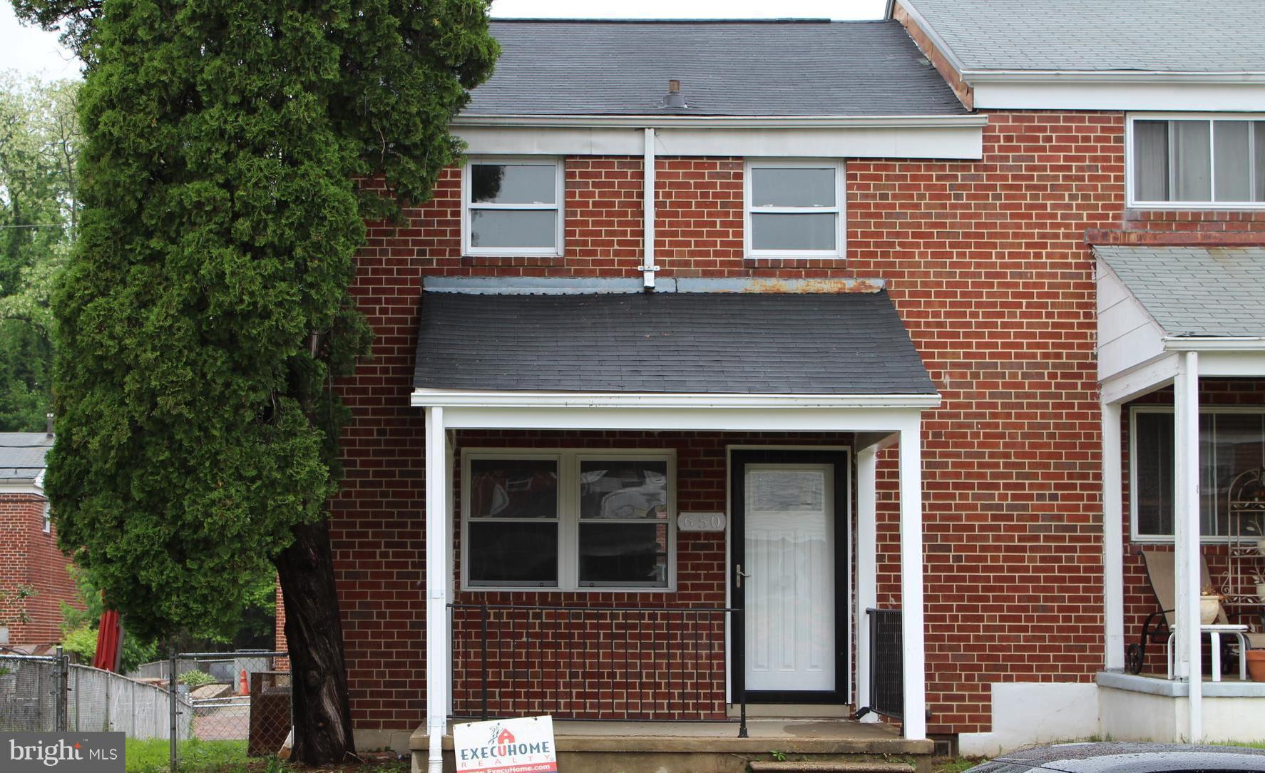 650 Queensgate Road Baltimore, MD 21229 - Photo 1 of 25 a view of a house with a door and a tree