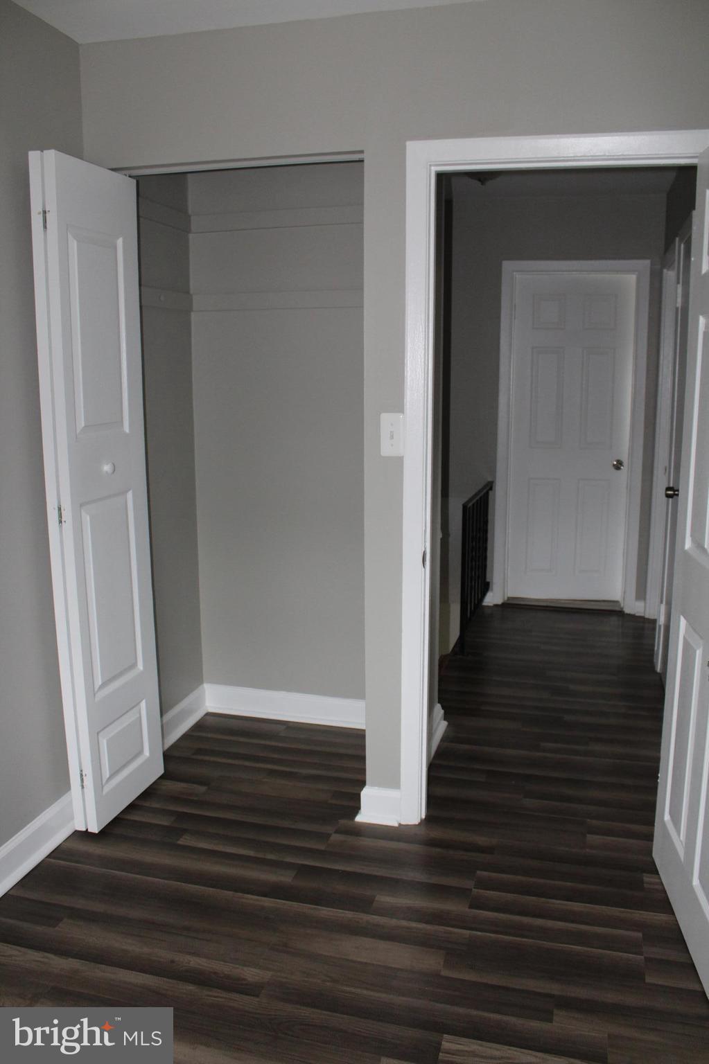 650 Queensgate Road Baltimore, MD 21229 - Photo 14 of 25 a view of a hallway with wooden floor and staircase
