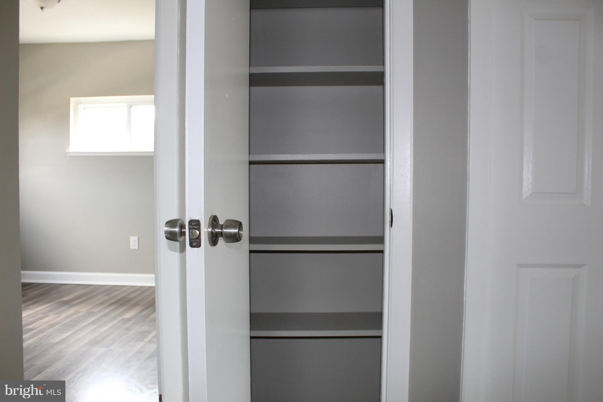 650 Queensgate Road Baltimore, MD 21229 - Photo 20 of 25 a view of walk in closet with empty racks