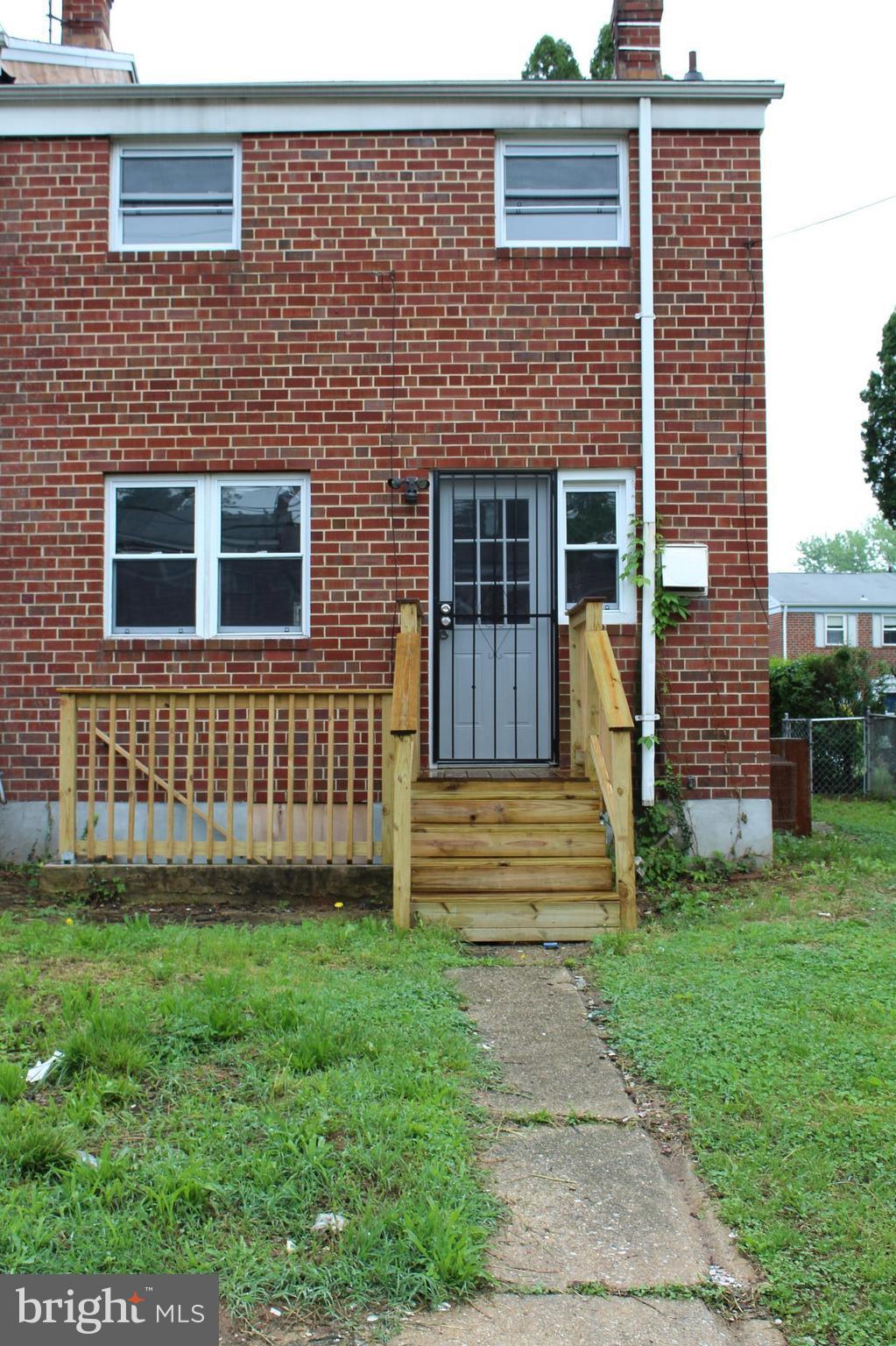 650 Queensgate Road Baltimore, MD 21229 - Photo 23 of 25 a front view of a house with garden