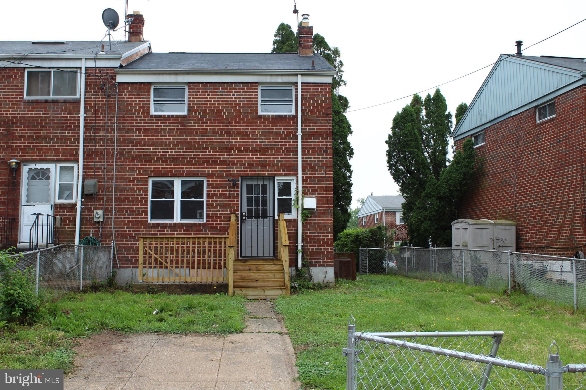 650 Queensgate Road Baltimore, MD 21229 - Photo 24 of 25 a front view of a house with a yard
