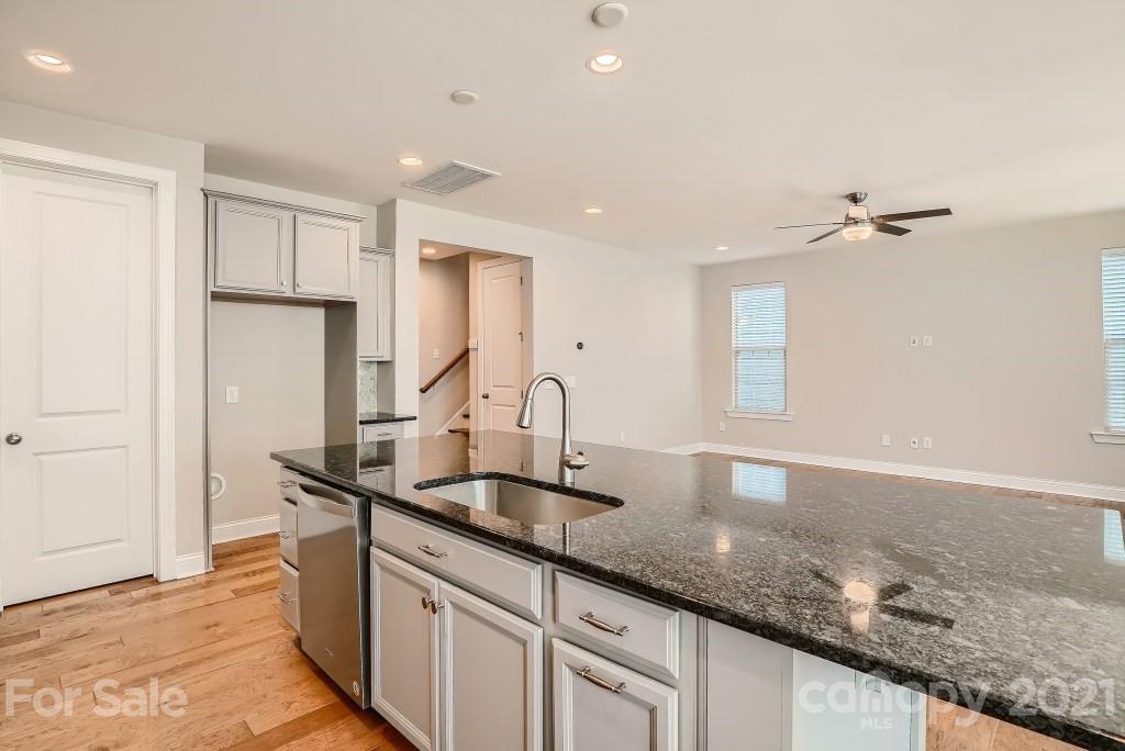 942 Emory Lane Fort Mill, SC 29708 - Photo 11 of 33 a kitchen with granite countertop a sink and a refrigerator