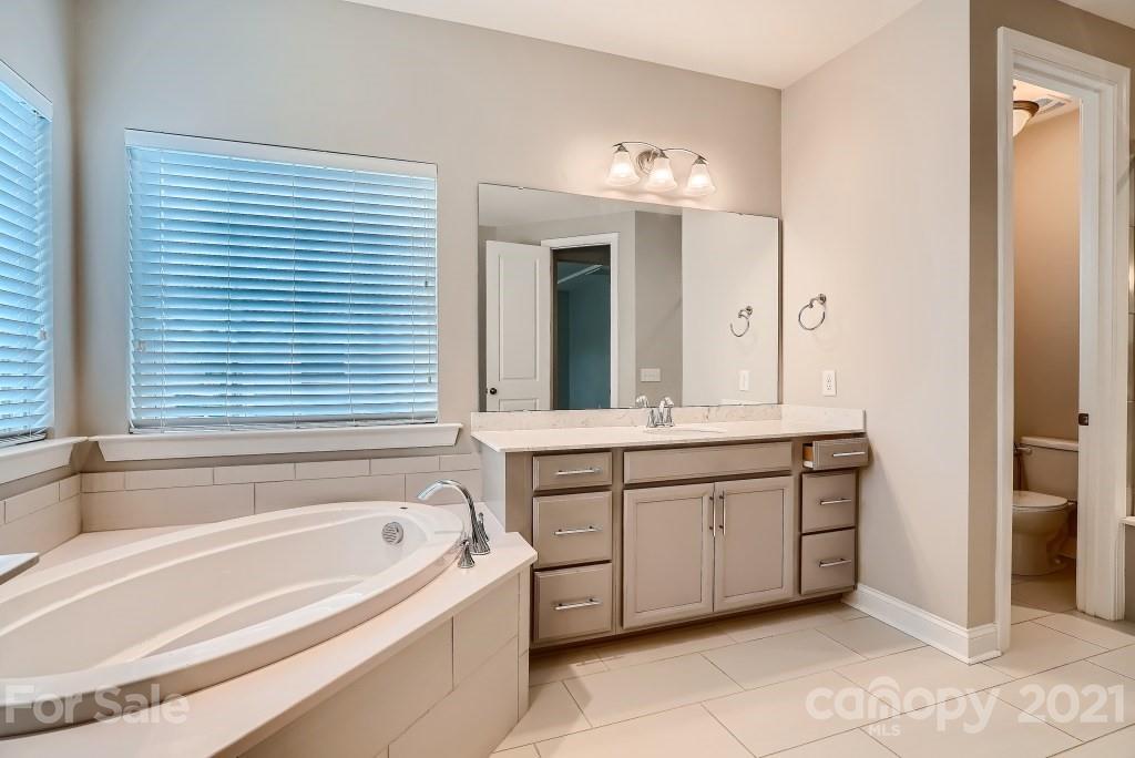 942 Emory Lane Fort Mill, SC 29708 - Photo 20 of 33 a spacious bathroom with a tub sink and mirror