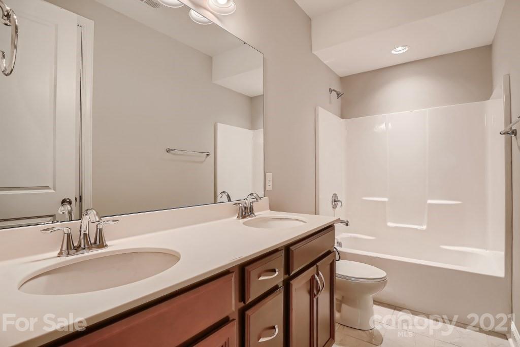 942 Emory Lane Fort Mill, SC 29708 - Photo 26 of 33 a bathroom with a granite countertop sink toilet and shower