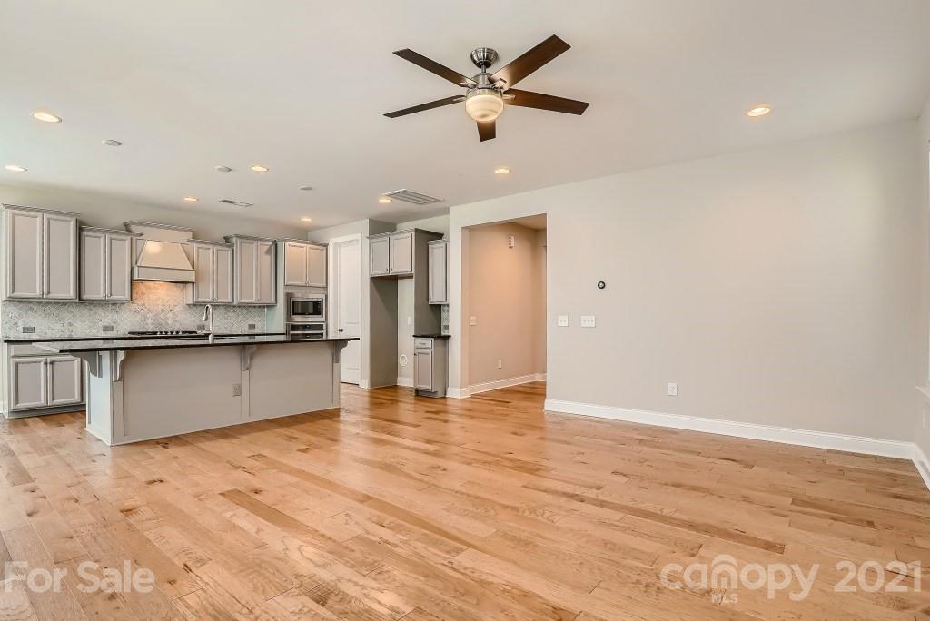 942 Emory Lane Fort Mill, SC 29708 - Photo 7 of 33 a view of kitchen with granite countertop cabinets and refrigerator