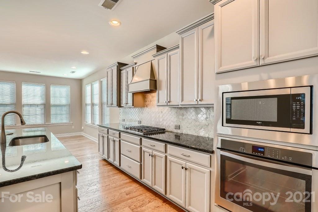 942 Emory Lane Fort Mill, SC 29708 - Photo 9 of 33 a kitchen with stainless steel appliances granite countertop a sink a stove microwave and cabinets