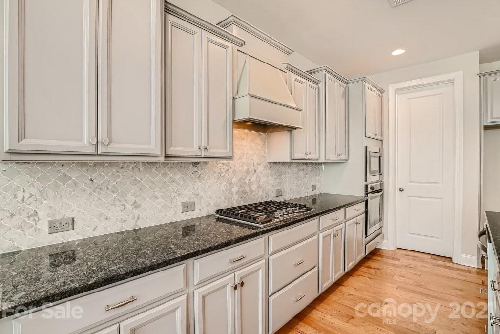 942 Emory Lane Fort Mill, SC 29708 - Photo 10 of 33 a kitchen with stainless steel appliances granite countertop a sink a stove and cabinets