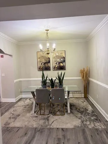 a dining room with furniture and chandelier