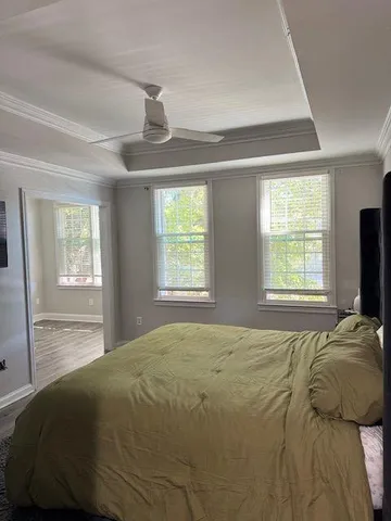 a bedroom with a bed and a window