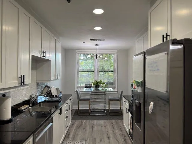 a kitchen with a table and chairs