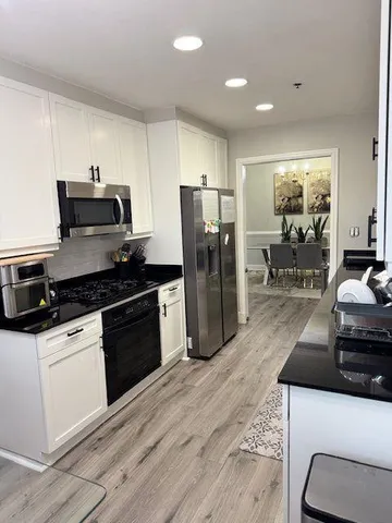 a kitchen with a sink stove and refrigerator