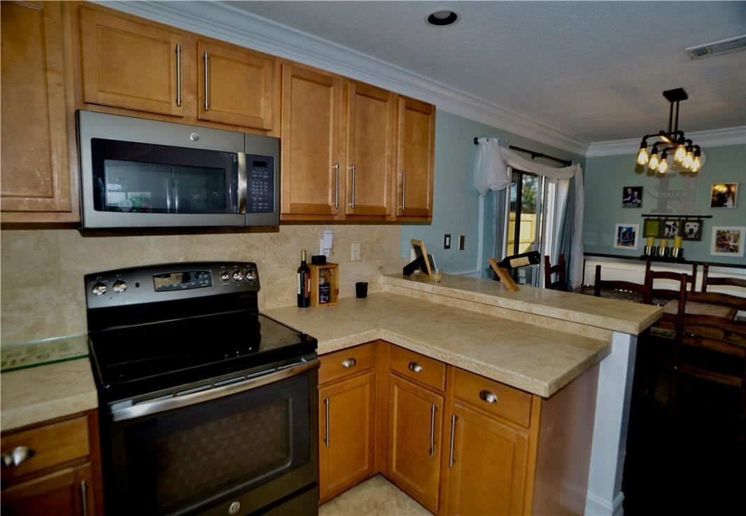 9812 Spanish Isles Drive Boca Raton, FL 33496 - Photo 14 of 44 a kitchen with a stove and a sink