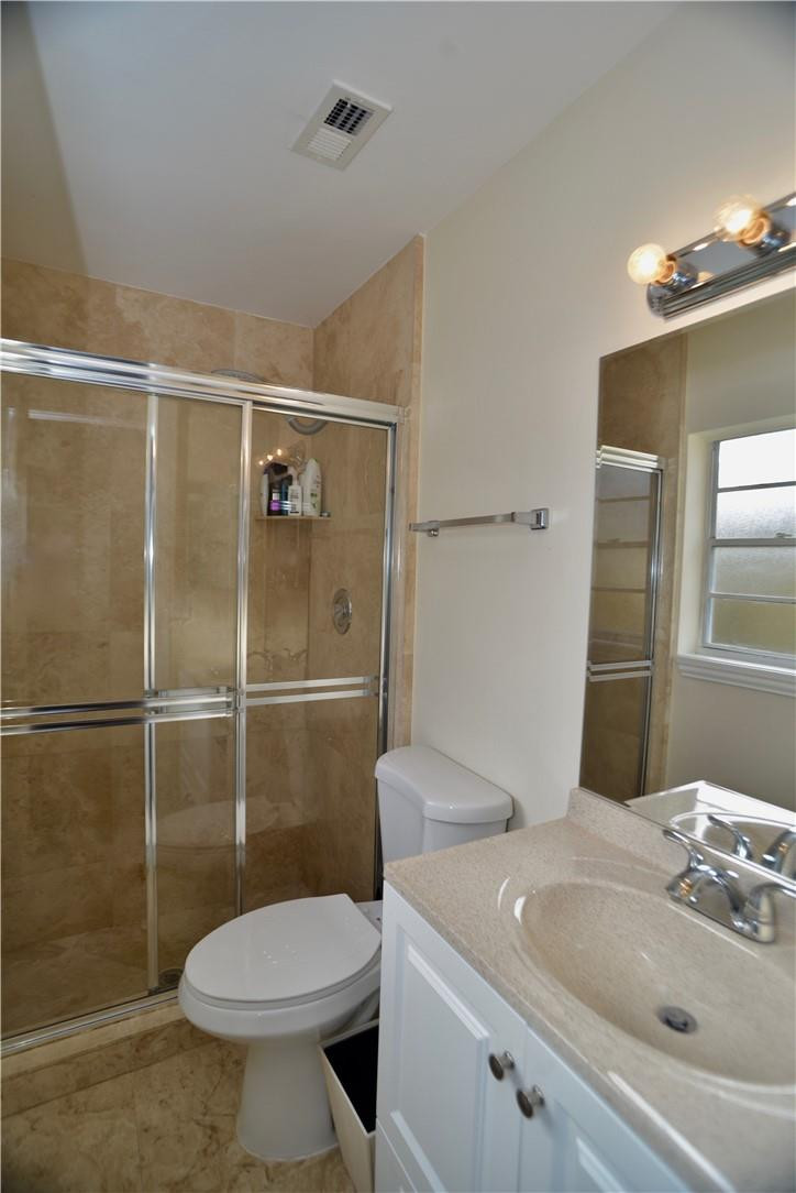 9812 Spanish Isles Drive Boca Raton, FL 33496 - Photo 23 of 44 a bathroom with a sink a toilet and shower