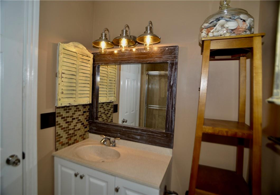 9812 Spanish Isles Drive Boca Raton, FL 33496 - Photo 28 of 44 a bathroom with a sink and a mirror