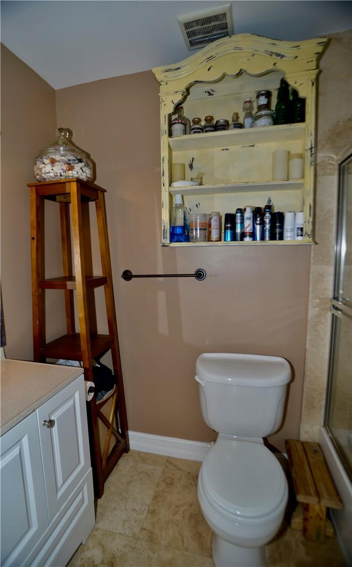 9812 Spanish Isles Drive Boca Raton, FL 33496 - Photo 30 of 44 a bathroom with a toilet sink and mirror