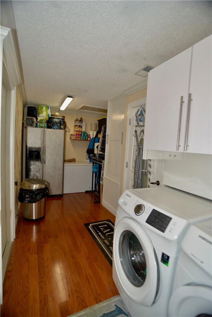 9812 Spanish Isles Drive Boca Raton, FL 33496 - Photo 38 of 44 a view of a kitchen with fridge and wooden floor