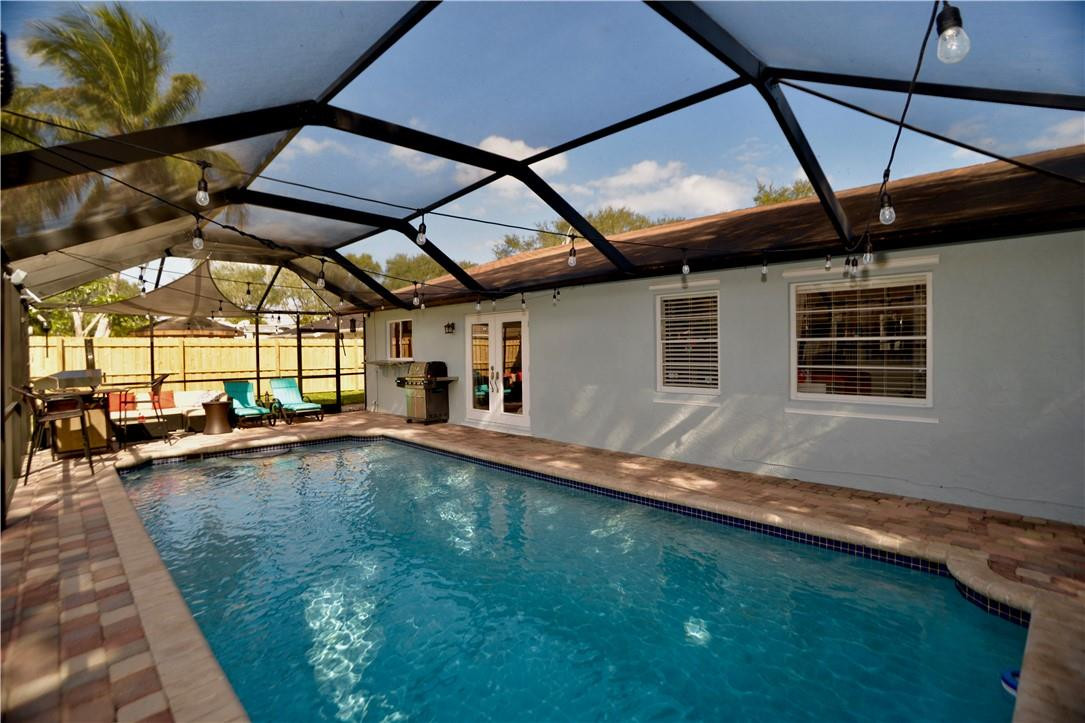 9812 Spanish Isles Drive Boca Raton, FL 33496 - Photo 39 of 44 a view of a backyard with pool table and chairs