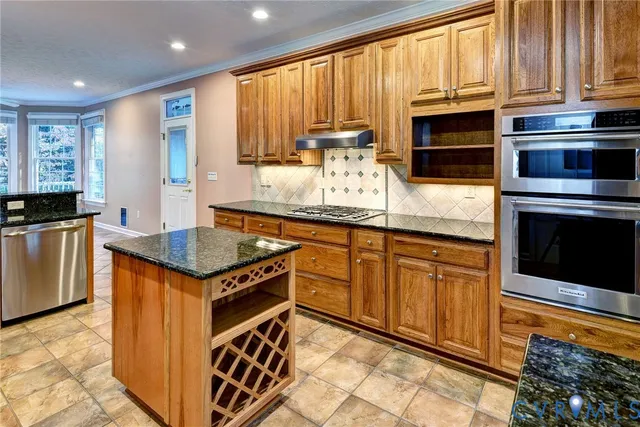 a kitchen with granite countertop stainless steel appliances a stove sink and microwave