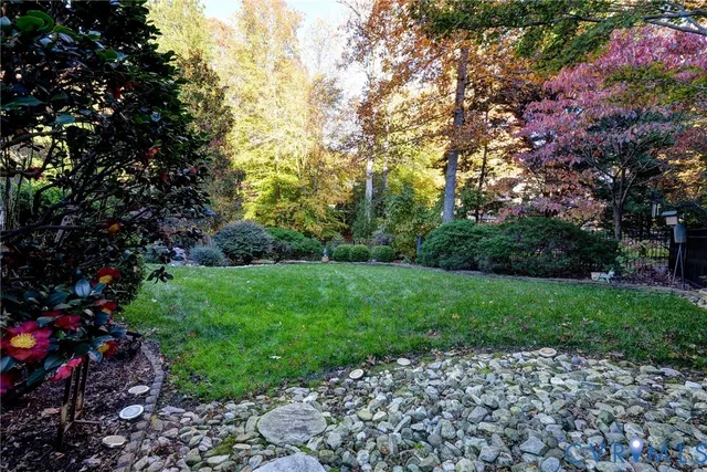 a view of a house with a yard and sitting area