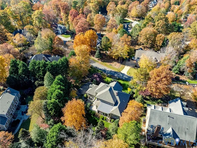 an aerial view of a house with a yard and mountain view in back