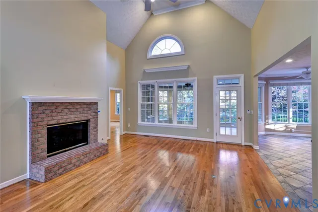 a view of an empty room window and wooden floor