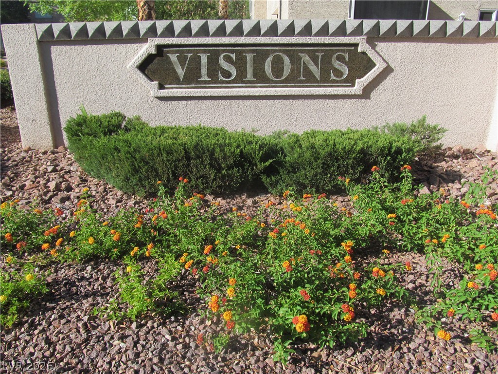 8701 Crescent Ridge Lane Las Vegas, NV 89134 - Photo 28 of 28 Artful landscaping with colorful blooms creates a captivating entrance to this inviting community.