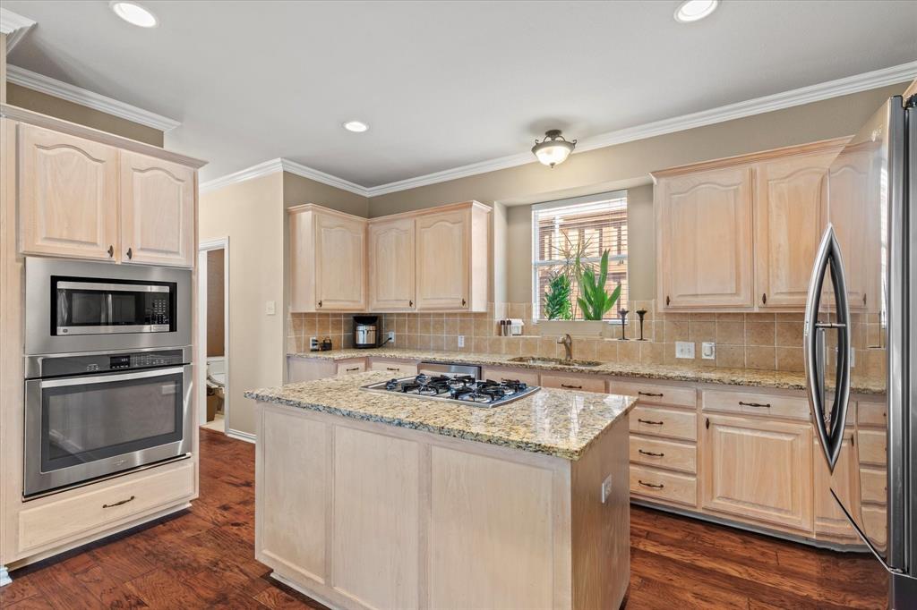 3710 Sam Rayburn Trail Dallas, TX 75287 - Photo 15 of 36 a kitchen with a stove a sink and a refrigerator