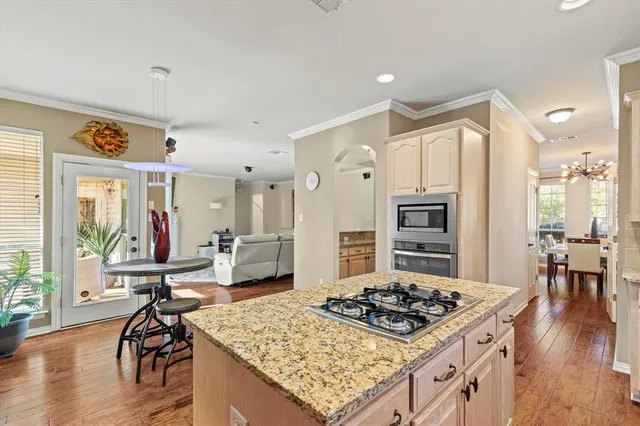 a kitchen with a stove a refrigerator and wooden floor