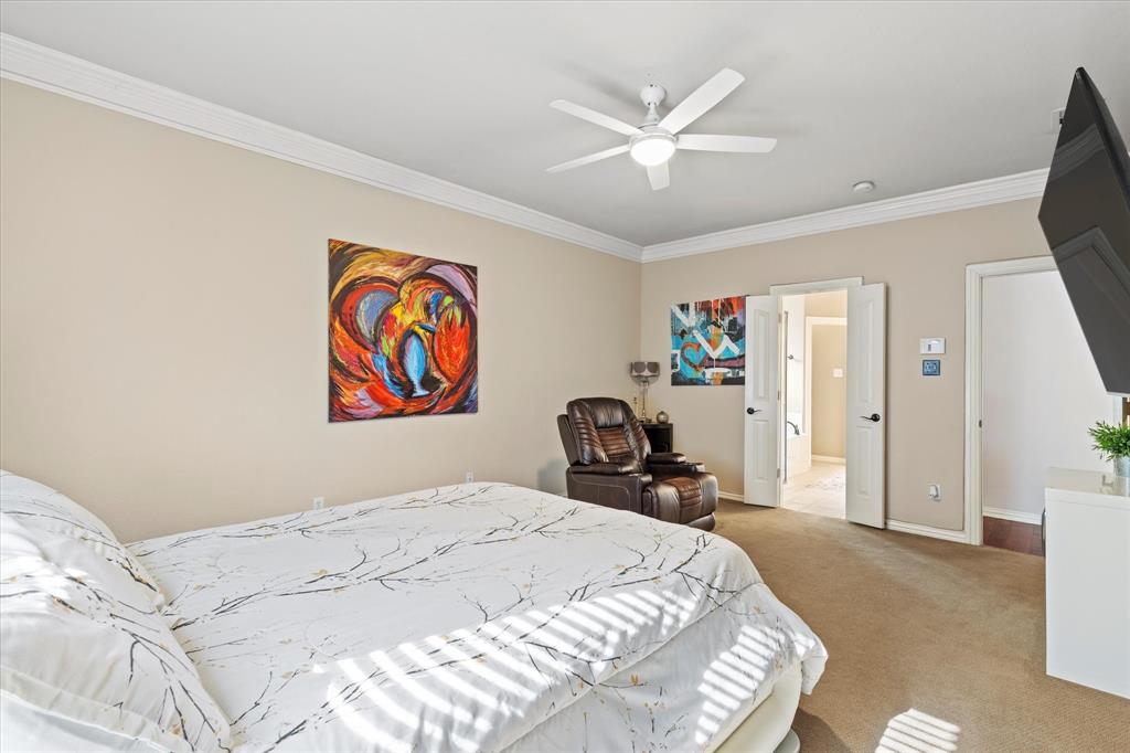 3710 Sam Rayburn Trail Dallas, TX 75287 - Photo 20 of 36 a bedroom with a bed and a chandelier