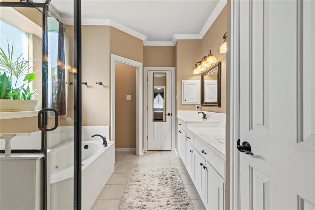 3710 Sam Rayburn Trail Dallas, TX 75287 - Photo 21 of 36 a bathroom with a glass shower door and a sink