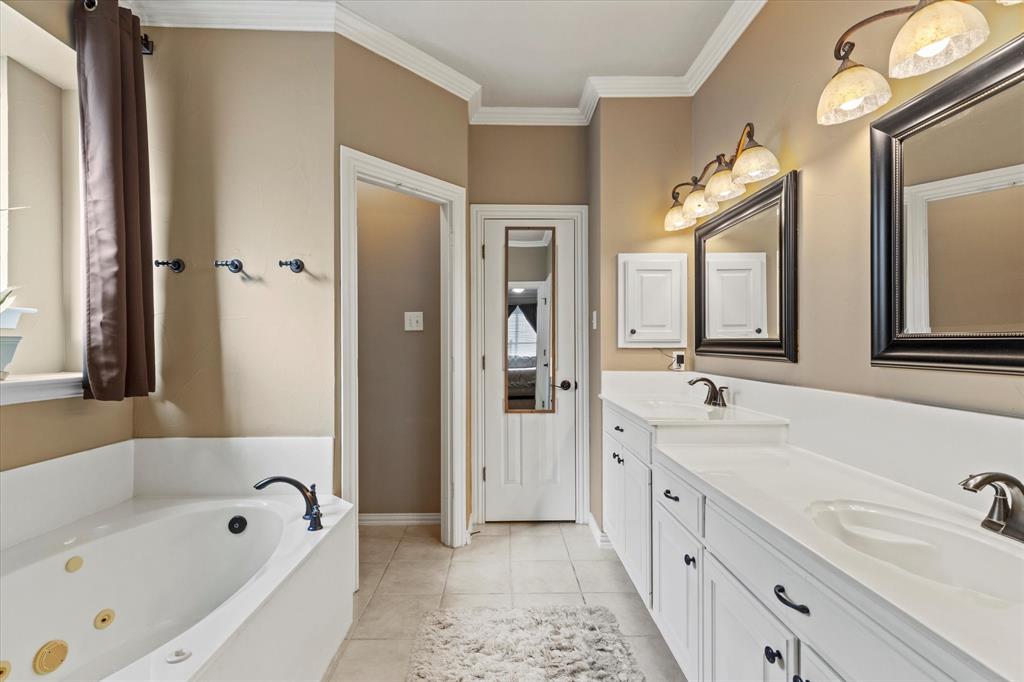 3710 Sam Rayburn Trail Dallas, TX 75287 - Photo 22 of 36 a spacious bathroom with a tub sink and mirror