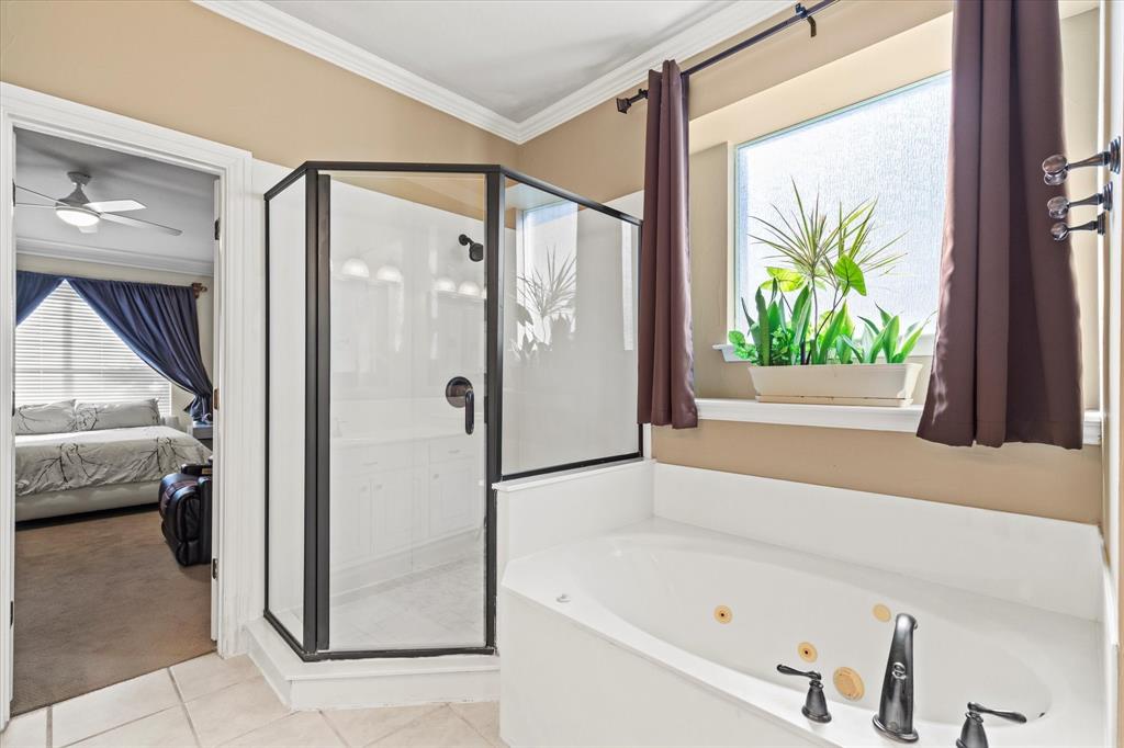 3710 Sam Rayburn Trail Dallas, TX 75287 - Photo 23 of 36 a bathroom with a bathtub and a shower