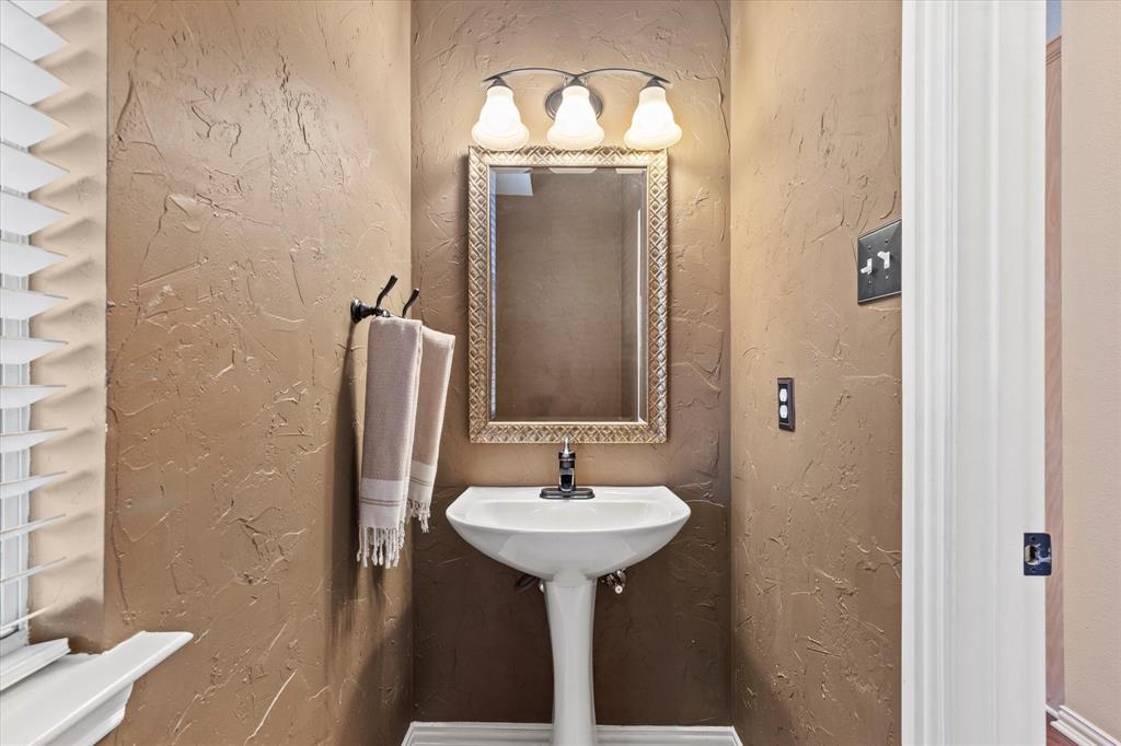 3710 Sam Rayburn Trail Dallas, TX 75287 - Photo 25 of 36 a bathroom with a sink and a mirror