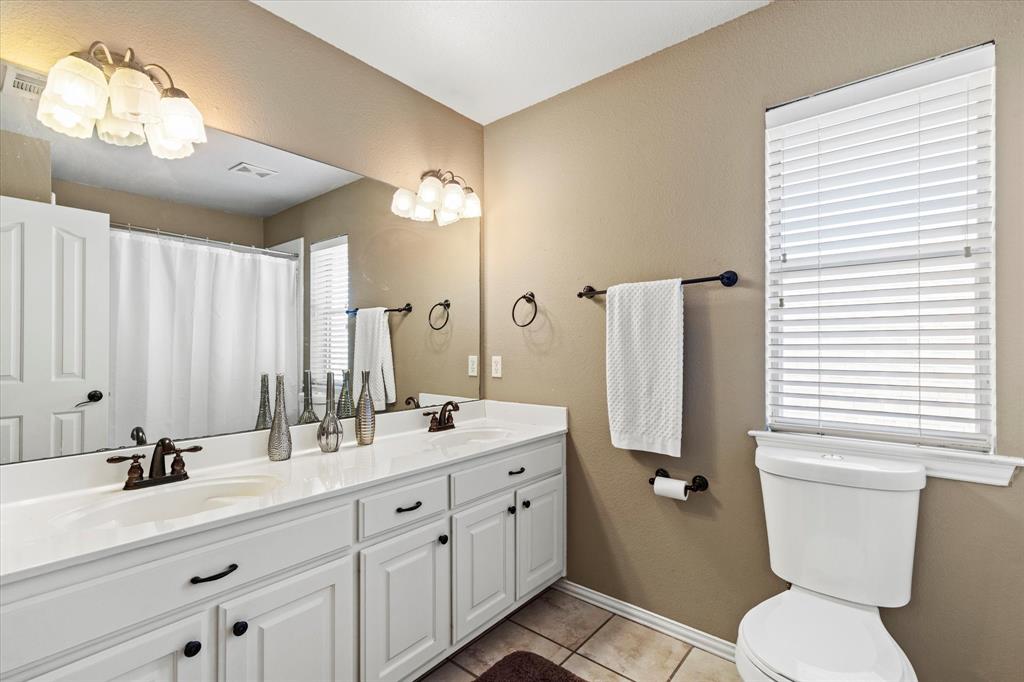 3710 Sam Rayburn Trail Dallas, TX 75287 - Photo 29 of 36 a bathroom with a double vanity sink mirror and toilet