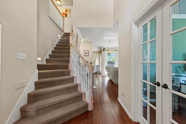 a view of entryway and hall with wooden floor