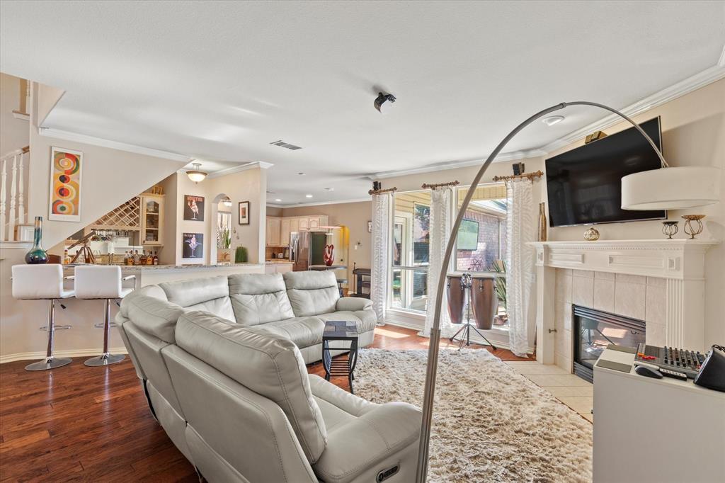 3710 Sam Rayburn Trail Dallas, TX 75287 - Photo 9 of 36 a living room with furniture a fireplace and a floor to ceiling window