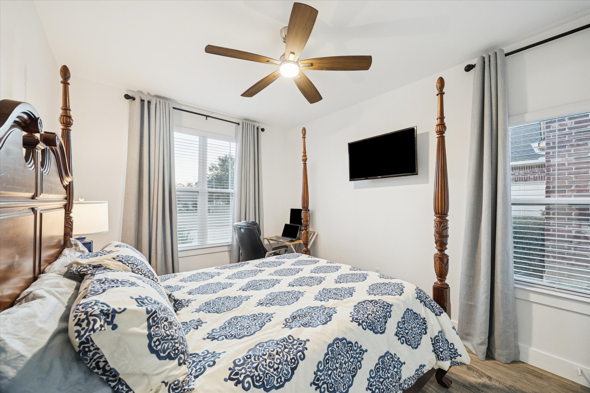203 Hampton Glen Road Montgomery, TX 77356 - Photo 23 of 35 This secondary bedroom is spacious and filled with abundant natural light from the large windows. The generous layout provides comfort and privacy, making it an ideal space for family members or guests to stay and relax.