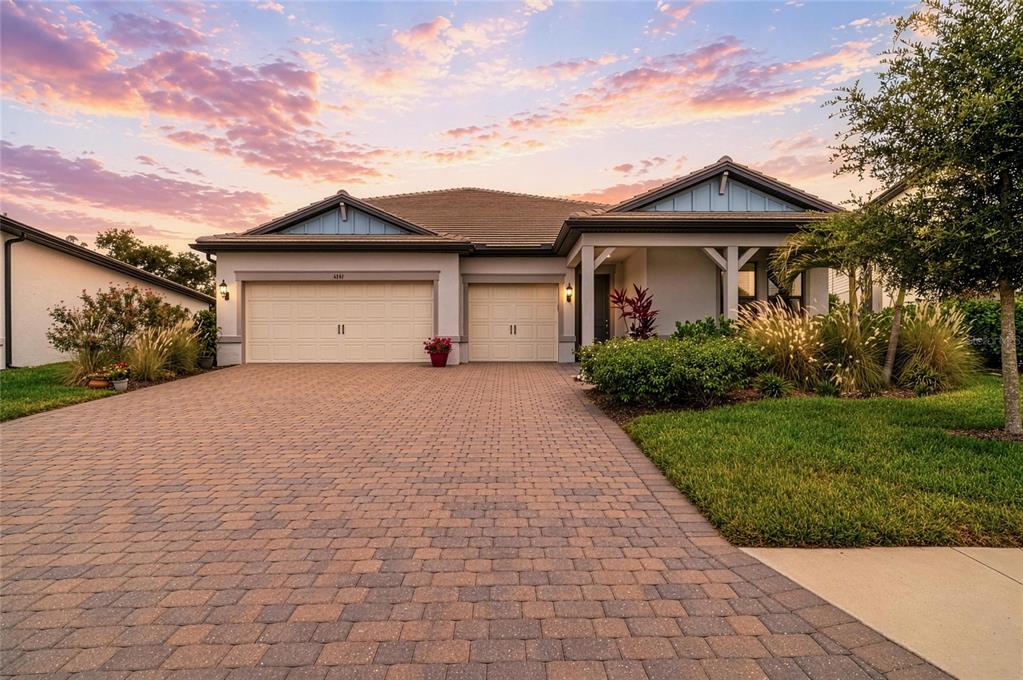 16341 Hidden Oak Loop Lakewood Ranch, FL 34211 - Photo 2 of 76 a front view of a house with a yard and garage