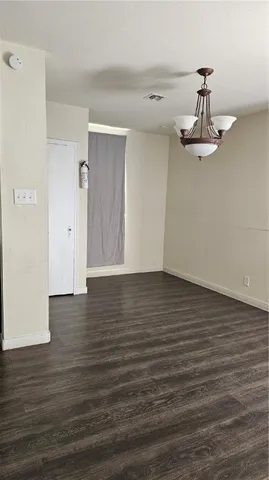 a view of a room with wooden floor and white walls