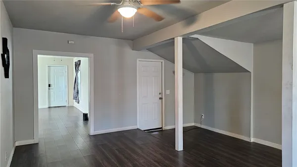 a view of a hallway with wooden floor